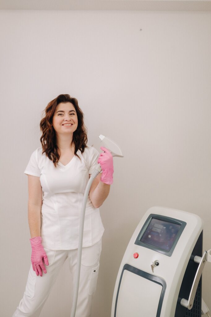 Portrait of the master of laser hair removal. A woman in a white coat holds a laser hair removal